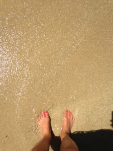 Toes in the sand on a beach in Hawaii 
